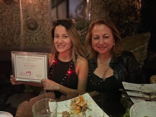 Sunna with a Women of Prosperous Hearts mentee holding a completion certificate